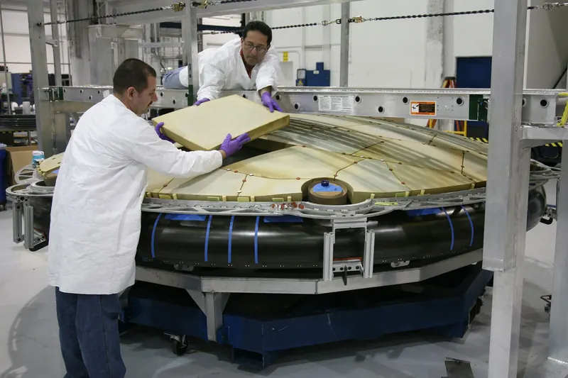 Mechanics assembling precision components at a modern manufacturing facility