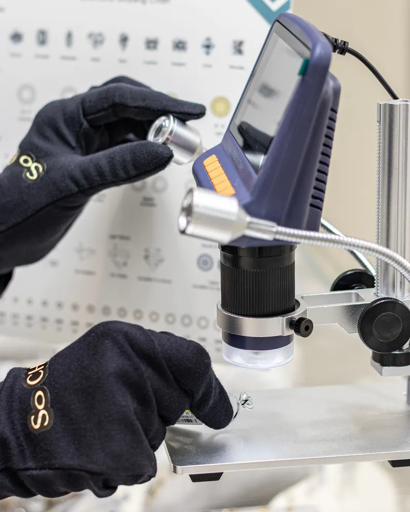 Gemstone analysis using a digital microscope by a gloved gemologist