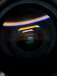 Close-up of a camera lens showcasing intricate reflections and glass patterns